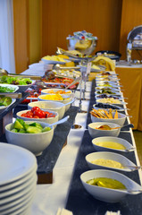 Buffet served table with snacks,fruits,canape,sweets and appetizers.Catering event plate service.Smorgasbord,food choice of breakfast in restaurant/Buffet line of lunch and dinner.Buffet self-service