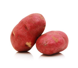 Close up of two red potatoes against white background.