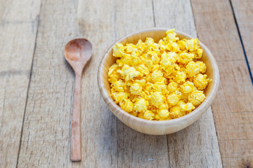 Popcorn cheese salty taste color yellow on wood blow on wooden table with copy space.