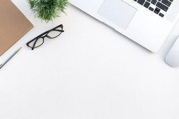Top view desk of work white table in office with laptop computer , notebook and stationary for creative business work or marketing plan to success planning of company