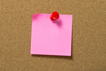 Red note pad attached to corkboard