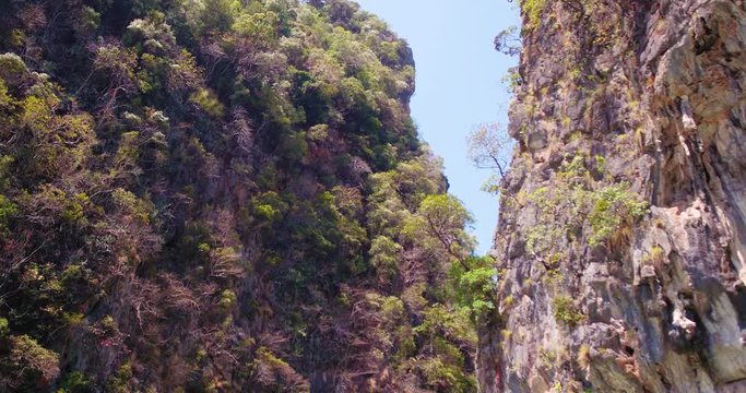 PHUKET, THAILAND, MARCH 2017:  Padling in small boats, through caves and alleys in Phi Phi Islands