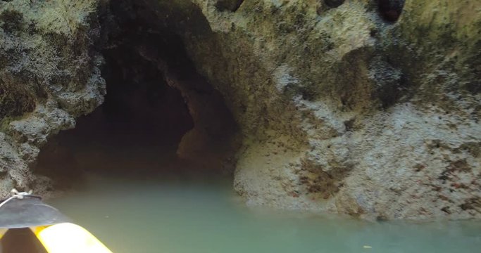 PHUKET, THAILAND, MARCH 2017:  Padling in small boats, through caves and alleys in Phi Phi Islands