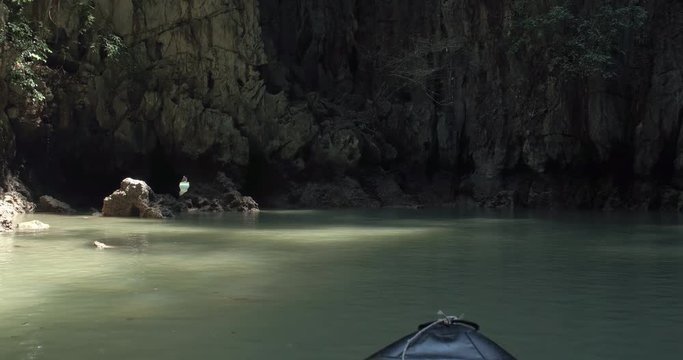 PHUKET, THAILAND, MARCH 2017:  Padling in small boats, through caves and alleys in Phi Phi Islands