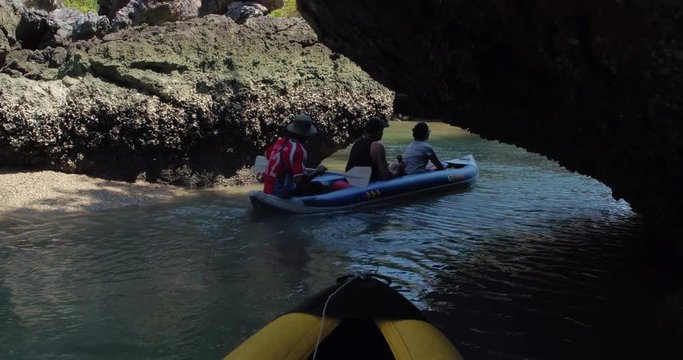 PHUKET, THAILAND, MARCH 2017:  Padling in small boats, through caves and alleys in Phi Phi Islands