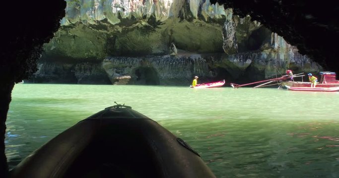 PHUKET, THAILAND, MARCH 2017:  Padling in small boats, through caves and alleys in Phi Phi Islands