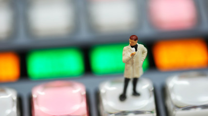 Miniature people : journalists , cameraman ,Videographer at work shooting on switcher control of...