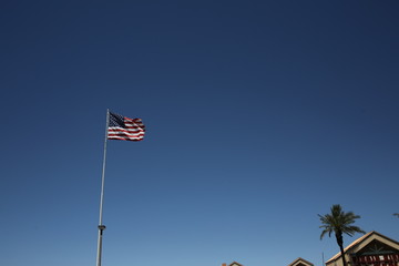 American flag on blue sky background