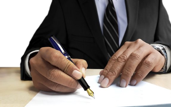 Man in suit writing on blank paper from front view angle