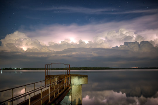 The bridge extends into the lake. And clouds, rainstorms and stars.