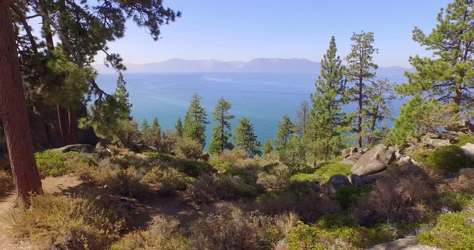 Scenic aerial flight toward beautiful Lake Tahoe panorama in Nevada. 4K UHD.