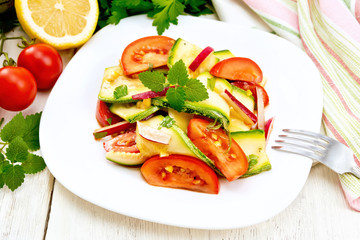 Salad with zucchini and vegetables on board