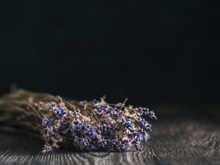 Bunch of lavender flowers on brown wooden table with copy space. Low key