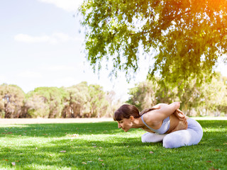 Young woman practicing yoga in the park