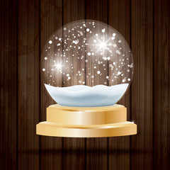 Christmas Crystal Ball with Snow on Wooden Background.