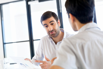 Image of two young business people in office