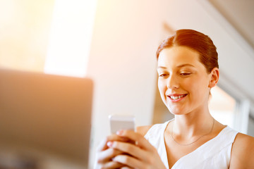 Portrait of young woman holding phone