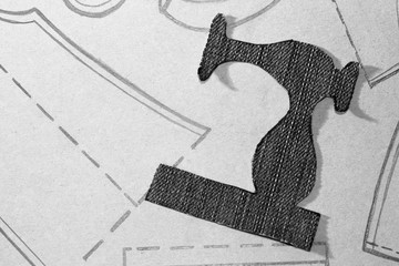 A stencil of a sewing machine of jeans, drawing clothing on paper