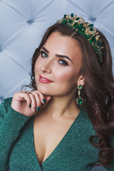 Woman in green dress and emerald crown