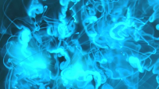 glowing bluish colored ink in water