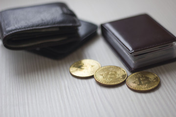 bitcoins and wallets on a wooden table