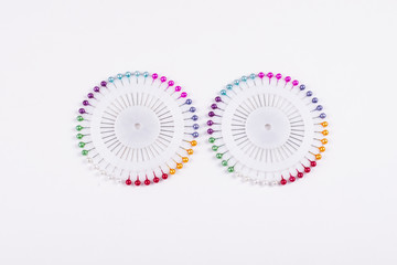 Set of multicolored pins on white background