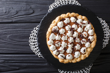 French silk pie is decorated with whipped cream and chocolate close-up. horizontal top view