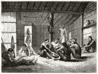 Native Dayak people ancient daily life in a hut. They get relaxing in a low indoor light. By Lancon after Dutch colonies iconographic atlas  published on Le Tour du Monde Paris 1862
