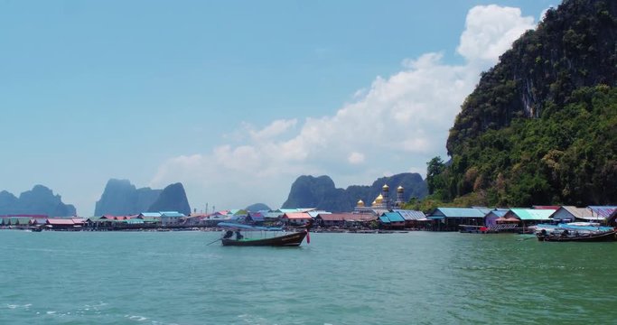 PHUKET, THAILAND, MARCH 2017: Ko Panyi floating village, viewed from boat in motion. 
