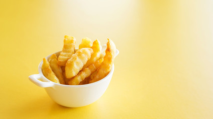 french fries on a yellow table.