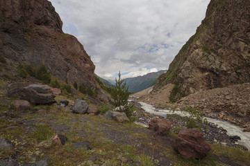 Summer views of the snowy mountains of the Caucasus. Formation and movement of clouds over mountains peaks.