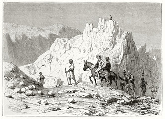 Ancient horseback traveler accompanied by oriental local guides trough a rocky landscape in Thebaid desert zone Egypt. Created by Girardet after Georges published on Le Tour du Monde Paris 1862
