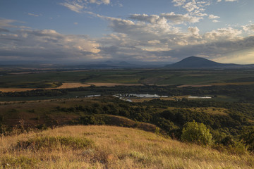 Obraz premium Summer views of the snowy mountains of the Caucasus. Formation and movement of clouds over mountains peaks.