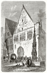 Ancient Big white medieval house next to a gothic fountain and people speaking each other. Old view of Ulm City Hall Germany. Created by Lancelot published on Le Tour du Monde Paris 1862