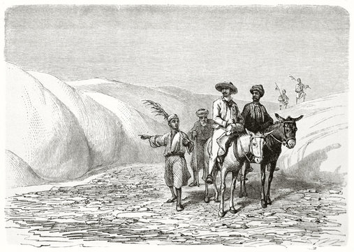 Ancient horseback traveler accompanied by oriental local guides trough the desert in Thebaid desert zone Egypt. Created by Girardet after Georges published on Le Tour du Monde Paris 1862