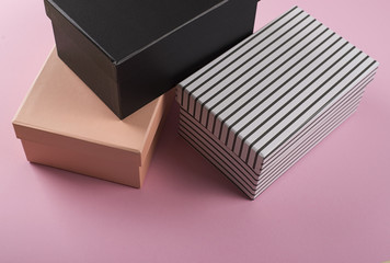 Several shoe boxes on pink background. Mockup.