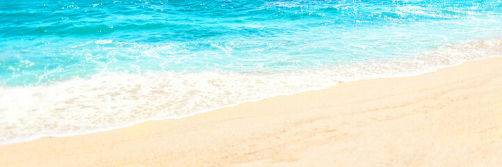 Soft wave of blue ocean on sandy beach Background with place for text. Tropical summer vacation concept.