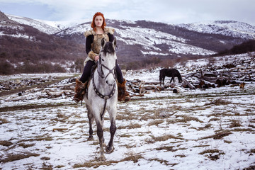 Viking woman with hammer in a traditional warrior clothes.
