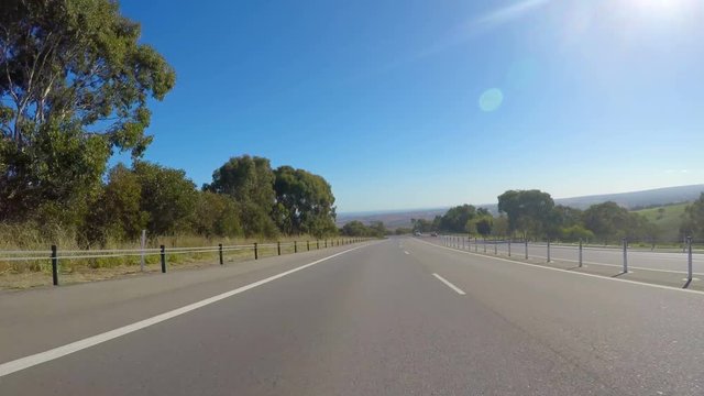 Vehicle POV, driving along freeway with scenic views of Willunga in McLaren Vale, South Australia.