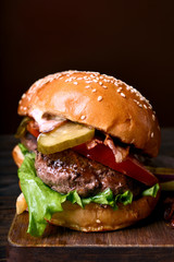 Hamburger with beef, fried bacon, onion, tomato, lettuce and marinated cucumber