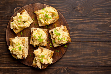 Sandwiches with scrambled eggs and green onion on bread
