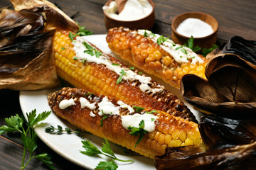 Grilled corn with greens and sauce