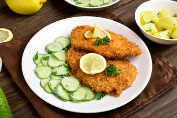 Tasty schnitzel with cucumber salad