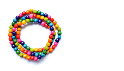 Multicolored wooden beads on a white background.