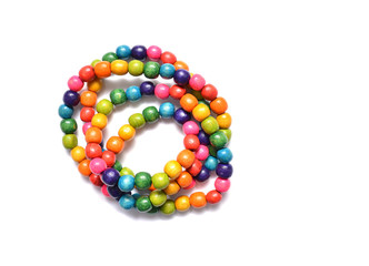 Multicolored wooden beads on a white background. Wooden necklace beads isolated