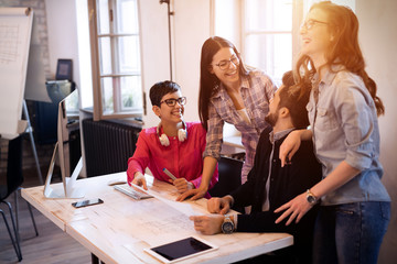 Coworkers working on project together in office
