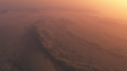 Fototapeta na wymiar Overhead shot of misty rocky desert at sunrise.