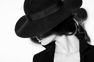 high fashion portrait of elegant woman in black and white hat and dress. Studio shot - Powered by Adobe