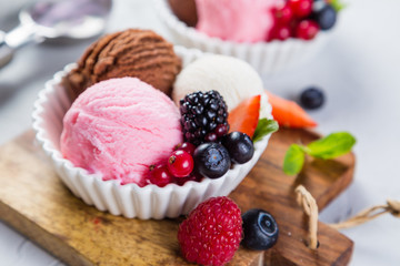 Selection of colorful ice cream scoops in white bowls