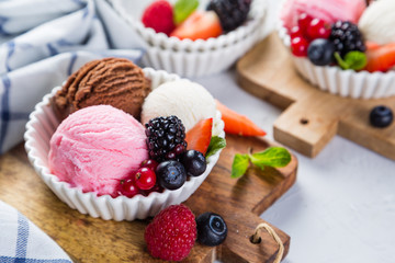 Selection of colorful ice cream scoops in white bowls